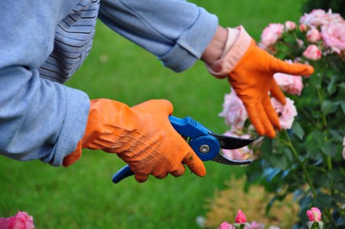 Gardener working on a suburban garden path in Shepherds Bush